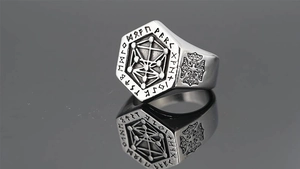 Detail of vintage Viking tree of life ring showing Nordic runes and geometric carvings