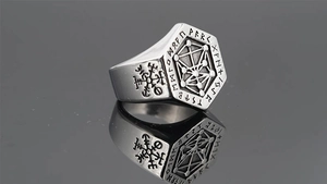 Macro shot of Viking Tree of Life signet ring with Nordic Runes and Vegvisir symbols