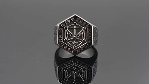 Macro shot of silver hexagon Viking ring showing tree of life and Nordic runes detail