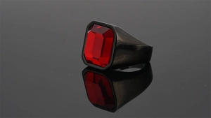 Detailed view of rectangle cut red gemstone set in a heavy black stainless steel band