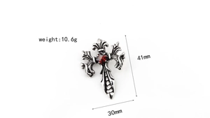 Detailed size view of retro gothic cross pendant with red gemstone and floral carvings