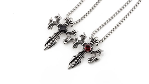 Detail of gothic sword pendants with red and black gems in vintage silver steel
