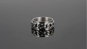 Detail shot of a silver stainless steel spinner ring with a rotatable chain design