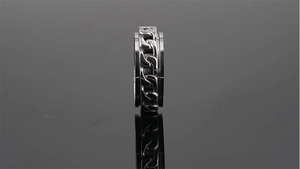 Close-up of rotatable silver stainless steel ring with unique chain-link texture