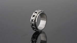 Close-up of polished stainless steel spinner ring with rotatable Cuban chain detail