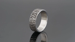 Macro shot of vintage tree bark texture on open adjustable ring with brushed metal interior