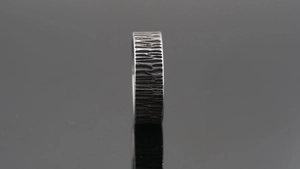 Macro shot of industrial vintage wide band ring with handcrafted tree bark texture