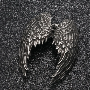 Gothic angel wing pendant necklace in vintage silver finish on black sparkling background