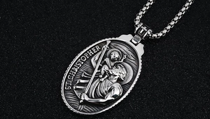 Macro view of vintage oval St. Christopher pendant with embossed detail on box chain
