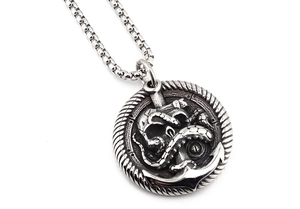 Macro shot of vintage silver octopus anchor pendant with detailed relief and box chain