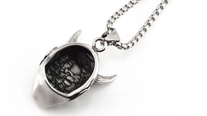 Detail view of vintage demon horn pendant with industrial frosted texture and steel chain