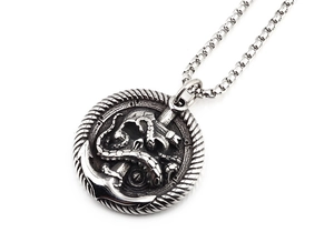 Detailed macro view of retro skull anchor and octopus pendant on box chain