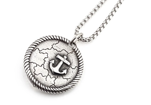 Detailed macro view of retro silver anchor pendant with nautic textures and box chain