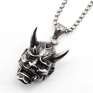 Japanese Hannya mask pendant necklace with red stone inlay on a silver box chain