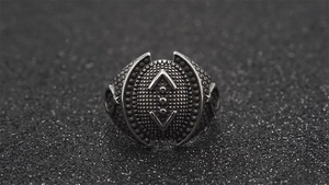 Detailed macro view of retro punk steel ring with Çukur symbol and scale texture