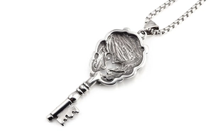 Détail du collier clé couronne argenté vintage avec relief gothique gravé