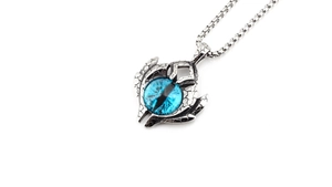 Macro shot of gothic dragon claw pendant with vibrant blue evil eye and aged finish
