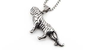 Detailed macro shot of vintage stainless steel tiger pendant with intricate stripes