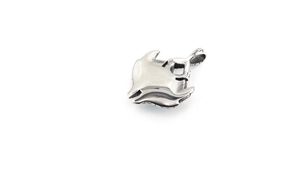 Macro detail of vintage silver wolf head pendant with oxidized textures and polished highlights
