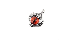 Macro detail of gothic devil eye pendant with cracked silver texture and red gemstone