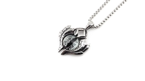 Detailed view of punk evil eye pendant with cracked vintage silver texture on box chain
