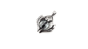 Macro detail of gothic evil eye pendant with vintage cracked metal texture and silver finish