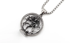 Macro detail of vintage Medusa steel pendant with silver finish and white zircon stones