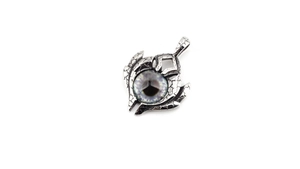 Close-up of gothic blue evil eye pendant with vintage cracked silver metal texture