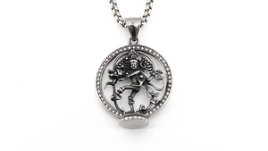Macro detail of vintage Medusa round pendant necklace with embossed Nataraja figure