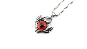 Macro detail of gothic necklace showing red eyeball pendant with silver cracked texture