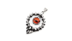 Détail macro du collier œil gothique avec pierre orange et monture en écailles de dragon