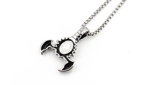 Close-up of scorpion pendant with polished oval inlay and sturdy round box chain link