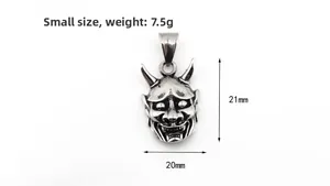 Detail view of a vintage stainless steel Hannya mask pendant with 7.5g weight and 21mm height