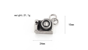 Macro view of vintage silver camera pendant showing 24mm by 15mm dimensions and 31.1g weight