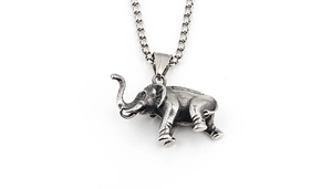 Detail of vintage silver elephant pendant with rich textures and matching chain