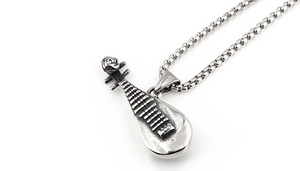 Macro detail of ancient silver stainless steel pipa lute pendant with textured neck strings