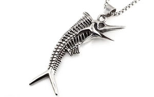Macro view of a detailed silver stainless steel swordfish skeleton pendant on a box chain