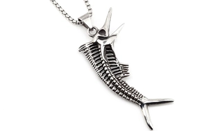 Macro shot of a gothic silver swordfish skeleton pendant on a box chain necklace