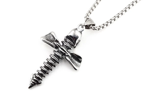 Detailed macro of vintage silver skull cross pendant with spinal bone texture design