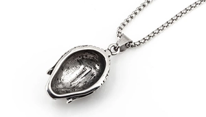 Detailed macro view of the vintage Buddha pendant back with textured silver finish