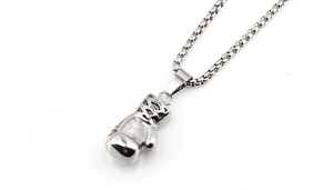 Detailed macro view of silver boxing glove pendant with polished finish and venetian chain