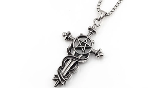 Macro shot of retro gothic sword pendant with star details in vintage silver finish
