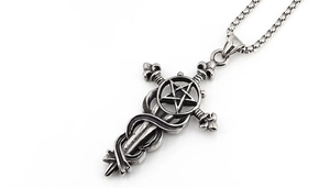 Detailed macro view of vintage stainless steel cross pendant with star and snake motifs
