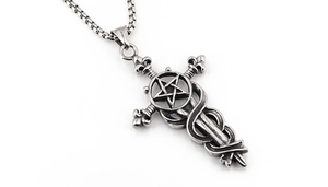 Close-up of vintage gothic cross pendant with snake and pentagram on silver box chain