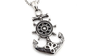 Macro view of vintage steel anchor and helm pendant with antique silver finish texture