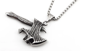 Detail of vintage silver axe pendant with textured finish on a stainless steel box chain