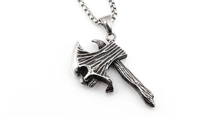 Macro view of titanium steel skull axe pendant with vintage etched texture and box chain