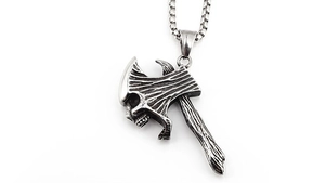 Detail of retro titanium steel axe pendant with skull engraving and wood texture handle