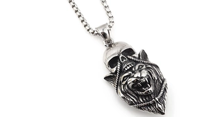 Close-up of gothic stainless steel necklace with 3D skull and roaring wolf head pendant