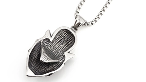 Macro detail of retro stainless steel wolf pendant back texture and box chain link